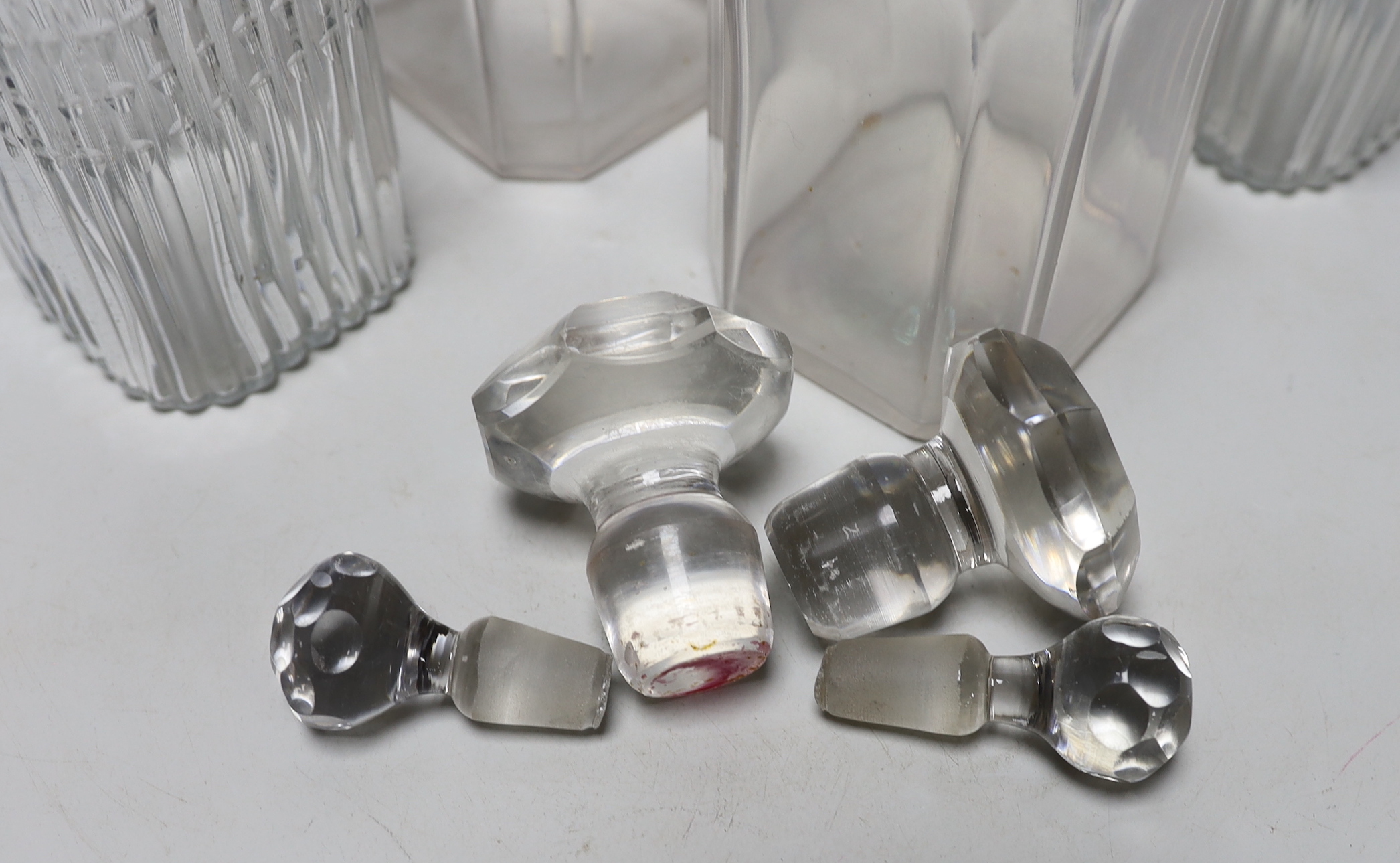 Two pairs of Georgian moulded and cut glass square decanters, all with lips, stoppers and ground pontils, highest 20cm (4)